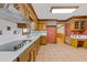 Traditional kitchen featuring tile flooring, wooden cabinets, and white countertops at 828 Jami Ct, Lawrenceville, GA 30046