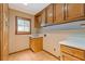 Functional laundry room featuring cabinets, sink, and window at 828 Jami Ct, Lawrenceville, GA 30046