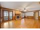Spacious living room featuring a brick fireplace, wood floors, and access to a sunroom at 828 Jami Ct, Lawrenceville, GA 30046