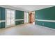 Bright living room with wainscoting, ample windows, and a view of adjacent room at 828 Jami Ct, Lawrenceville, GA 30046