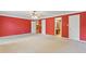 Spacious main bedroom with red walls and carpet flooring provides access to bathroom and walk in closet at 828 Jami Ct, Lawrenceville, GA 30046