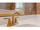 Close-up of a vanity with gold fixtures and a white countertop at 828 Jami Ct, Lawrenceville, GA 30046