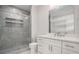 Modern bathroom featuring glass shower, gray tile, and white vanity at 953 Mystic Way, Hampton, GA 30228