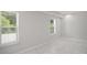 Bedroom with white tile flooring and view to the exterior at 953 Mystic Way, Hampton, GA 30228