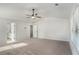 Spacious carpeted bedroom with ceiling fan and ensuite bathroom offers comfort and convenience at 953 Mystic Way, Hampton, GA 30228
