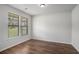 This bedroom features hardwood floors and two windows that let in a lot of natural light at 953 Mystic Way, Hampton, GA 30228