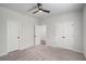 Carpeted bedroom with ceiling fan and two closets, including one that is a walk-in, for plenty of storage at 953 Mystic Way, Hampton, GA 30228