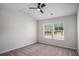 Bedroom with neutral carpet, ceiling fan and view to the exterior at 953 Mystic Way, Hampton, GA 30228