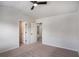 Bedroom with neutral carpet, ceiling fan, walk-in closet and view to the hallway at 953 Mystic Way, Hampton, GA 30228