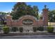 Traditions at Crystal Lake entrance with a brick sign, stone accents, and wrought iron gate at 953 Mystic Way, Hampton, GA 30228