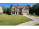 Attractive two-story brick home with a lush green lawn, two-car garage, and tidy landscaping at 953 Mystic Way, Hampton, GA 30228