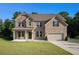 Inviting two-story brick home with a well-kept lawn, two-car garage, and pleasant neighborhood setting at 953 Mystic Way, Hampton, GA 30228