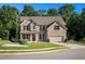 Charming two-story brick home with a manicured lawn, two-car garage, and attractive landscaping at 953 Mystic Way, Hampton, GA 30228