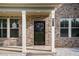 Close-up of the front door, showcasing brick facade, columns, and the house number, 953 at 953 Mystic Way, Hampton, GA 30228