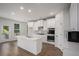 Bright kitchen featuring white cabinets, stainless steel appliances, and a center island at 953 Mystic Way, Hampton, GA 30228