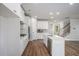 Bright kitchen featuring white cabinets, stainless steel appliances, and a center island at 953 Mystic Way, Hampton, GA 30228