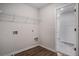 Laundry room with wire shelves, washer and dryer hookups, and laminate wood flooring at 953 Mystic Way, Hampton, GA 30228