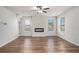 Bright living room with hardwood floors, a modern fireplace, large windows, and neutral decor at 953 Mystic Way, Hampton, GA 30228
