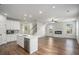Open concept living room and kitchen with hardwood floors and modern appliances at 953 Mystic Way, Hampton, GA 30228