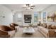 Cozy, staged living room featuring hardwood floors, modern fireplace, neutral walls, and stylish furniture at 953 Mystic Way, Hampton, GA 30228