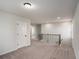 Loft featuring neutral carpet and a wood and iron railing at 953 Mystic Way, Hampton, GA 30228