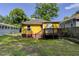 A cozy home featuring a wooden deck overlooking a grassy backyard with mature trees providing shade at 103 Chicamauga Sw Ave, Atlanta, GA 30314