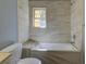 Bathroom with tub, tiled shower and window at 103 Chicamauga Sw Ave, Atlanta, GA 30314