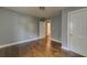 This bedroom features hardwood floors, access to the bathroom, and neutral paint at 103 Chicamauga Sw Ave, Atlanta, GA 30314