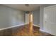 Bright bedroom with hardwood floors and neutral walls, leading to an attached bathroom at 103 Chicamauga Sw Ave, Atlanta, GA 30314