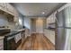 Well-lit kitchen features ample counter space, stainless steel appliances, and wood look flooring at 103 Chicamauga Sw Ave, Atlanta, GA 30314