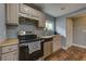 Functional kitchen with stainless steel appliances, laminate countertop, and stylish wood-look floors at 103 Chicamauga Sw Ave, Atlanta, GA 30314