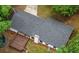 Aerial view of a house with a gray roof, a wooden deck and a backyard surrounded by trees at 1192 Sandalwood Dr, Lawrenceville, GA 30043