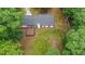 Aerial view of a home featuring a large backyard and wooden deck, surrounded by mature trees at 1192 Sandalwood Dr, Lawrenceville, GA 30043
