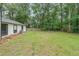 Sprawling backyard with green grass and views of the trees and woods at 1192 Sandalwood Dr, Lawrenceville, GA 30043