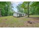 Landscaped backyard with mature trees and a fenced perimeter at 1192 Sandalwood Dr, Lawrenceville, GA 30043