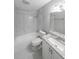 Updated bathroom featuring a shower-tub combo, granite countertop, and modern fixtures at 1192 Sandalwood Dr, Lawrenceville, GA 30043