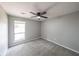 Comfortable bedroom featuring neutral carpet, a ceiling fan, and a window providing natural light at 1192 Sandalwood Dr, Lawrenceville, GA 30043