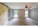 Large bedroom with gray carpet, a ceiling fan, a sliding barn door, and two large windows at 1192 Sandalwood Dr, Lawrenceville, GA 30043