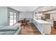 Dining area open to kitchen with sliding doors to the deck and quartz counter bar at 1192 Sandalwood Dr, Lawrenceville, GA 30043