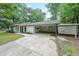 A single-story home featuring covered parking and a well-manicured lawn at 1192 Sandalwood Dr, Lawrenceville, GA 30043