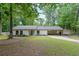 Charming one-story home with a well-maintained lawn and covered parking space at 1192 Sandalwood Dr, Lawrenceville, GA 30043