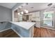 Updated kitchen with modern pendant lights, white cabinets, and stainless steel appliances at 1192 Sandalwood Dr, Lawrenceville, GA 30043
