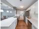 Kitchen features quartz counters, stainless appliances, and opens to dining room at 1192 Sandalwood Dr, Lawrenceville, GA 30043