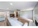 Spacious living room with hardwood floors, recessed lighting, fireplace, and an open view of the updated kitchen at 1192 Sandalwood Dr, Lawrenceville, GA 30043