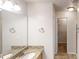 Bright bathroom with a granite countertop vanity and a walk-in closet in view at 150 Mills Creek Ln, Covington, GA 30016