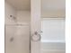 Bright bathroom featuring a glass shower enclosure and a window with blinds at 150 Mills Creek Ln, Covington, GA 30016