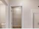 Bathroom with a view into the walk-in closet with plenty of shelving and storage space at 150 Mills Creek Ln, Covington, GA 30016