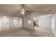 Open living room area with vaulted ceiling, ceiling fan, and kitchen view at 150 Mills Creek Ln, Covington, GA 30016