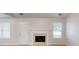 Bright living room with fireplace, door, and window at 150 Mills Creek Ln, Covington, GA 30016