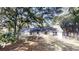 Backyard view showcasing a single story home and mature trees at 2530 Flippen Rd, Stockbridge, GA 30281